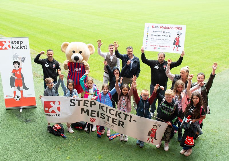 Spielende Kinder auf dem Bundeszentralen Weltkindertagsfest in Berlin, mit dem DFL-Stiftung Stand im Hintergrund.